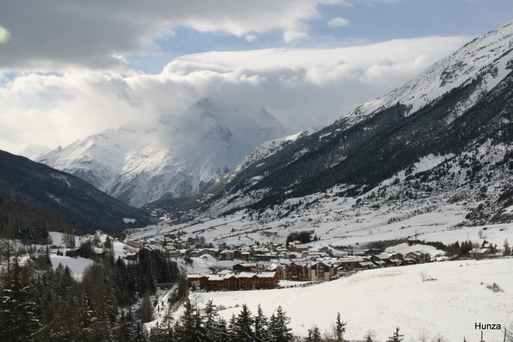 Lanslevillard vu depuis le chemin du Petit-Bonheur avec la Dent Parrachée en arrière-plan et sous ciel chargé de nuages
