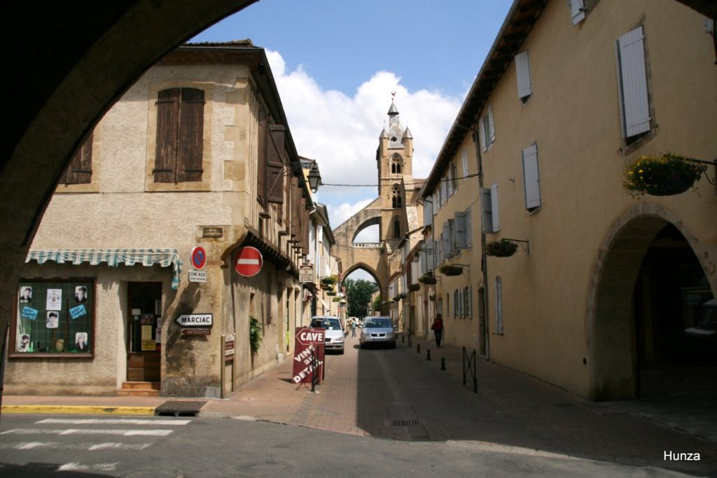 Rue de l'Évêché à Mirande avec l'église Sainte-Marie en arrière-plan